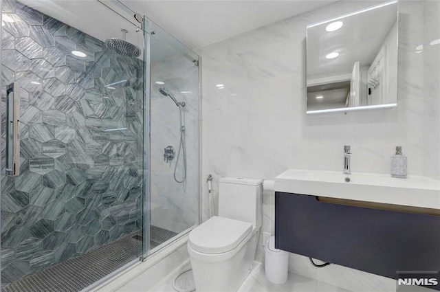 full bathroom featuring vanity, toilet, tile walls, and a shower stall