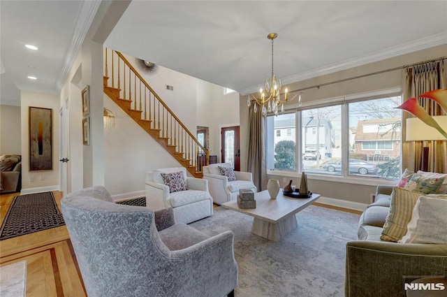 living room featuring crown molding, baseboards, a chandelier, stairs, and recessed lighting