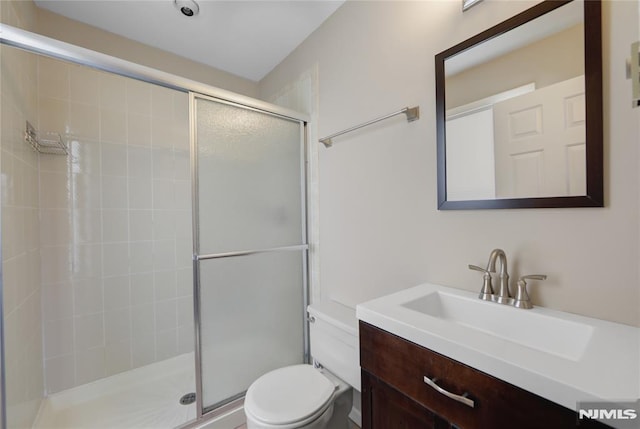 full bath featuring a shower stall, toilet, and vanity