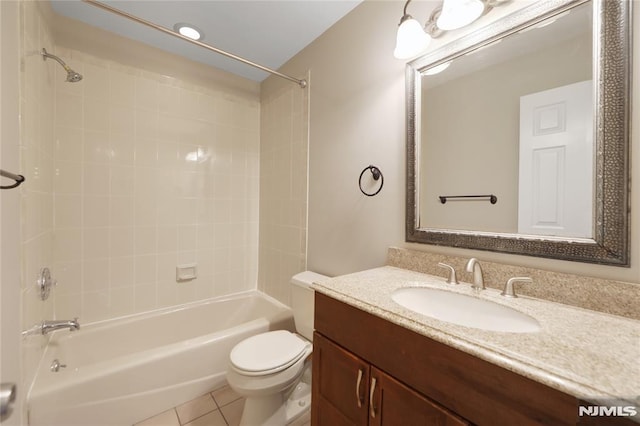 bathroom featuring toilet, washtub / shower combination, vanity, and tile patterned floors