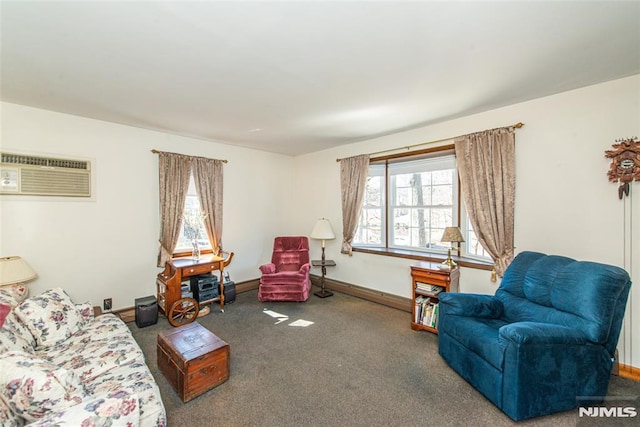 carpeted living area with an AC wall unit and baseboards