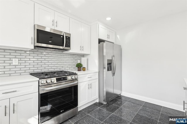 kitchen with backsplash, granite finish floor, appliances with stainless steel finishes, light countertops, and baseboards