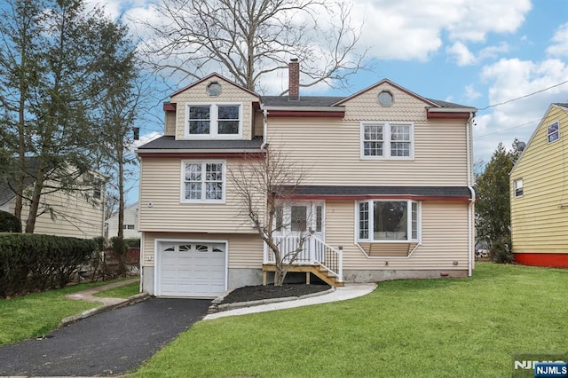 view of front of house with a front lawn, aphalt driveway, a garage, and a chimney