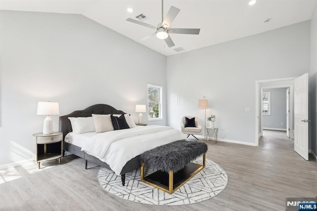 bedroom featuring a ceiling fan, baseboards, high vaulted ceiling, recessed lighting, and light wood-style floors