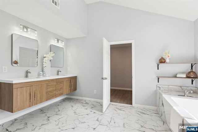 full bath featuring visible vents, baseboards, double vanity, marble finish floor, and a sink