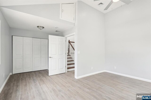 unfurnished bedroom with visible vents, baseboards, wood finished floors, a closet, and a ceiling fan