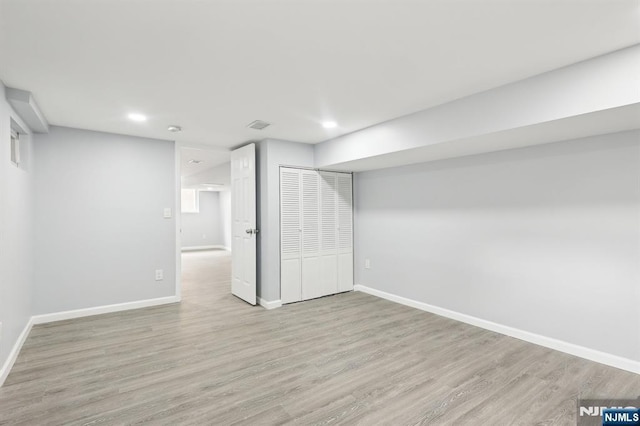 finished basement featuring visible vents, recessed lighting, wood finished floors, and baseboards