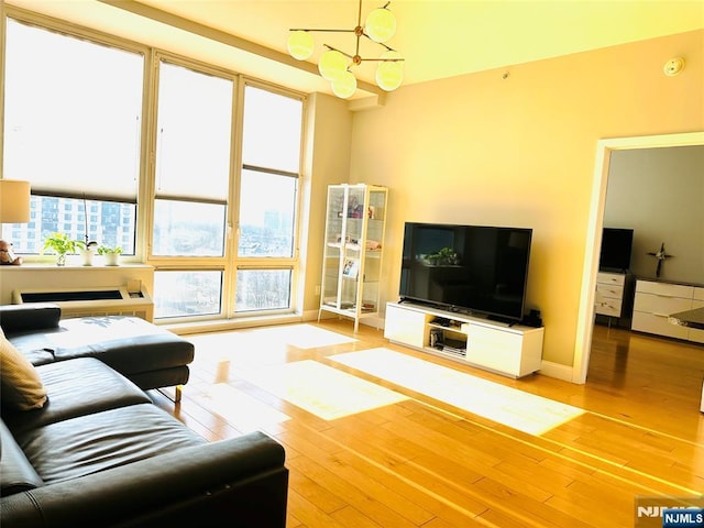 living area with baseboards and wood finished floors