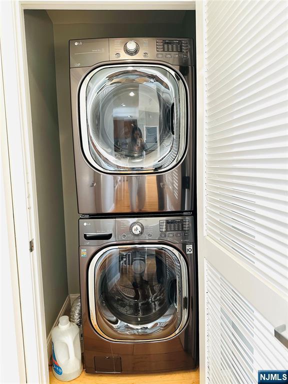 laundry area featuring laundry area and stacked washer / dryer