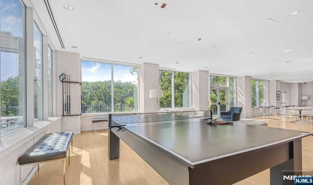 playroom with light wood-style flooring and recessed lighting