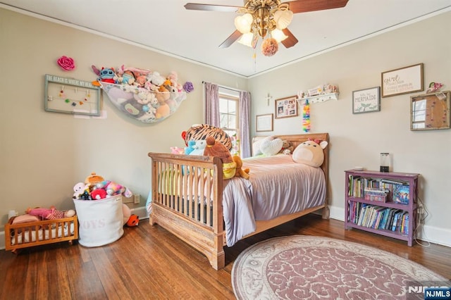 bedroom featuring a ceiling fan, wood finished floors, and baseboards