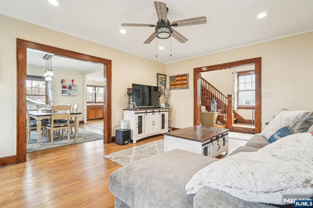 living area featuring recessed lighting, a ceiling fan, light wood-style floors, and stairs