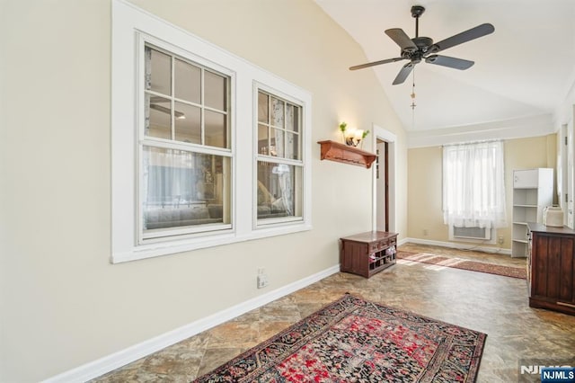 interior space featuring vaulted ceiling, baseboards, and ceiling fan