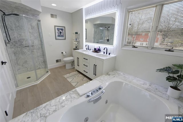 bathroom featuring a stall shower, visible vents, and a sink