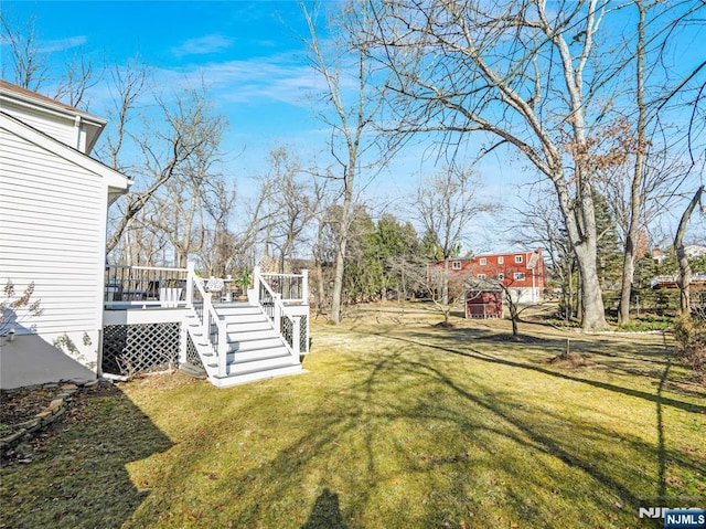 view of yard featuring a wooden deck and stairs