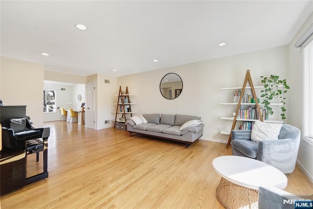 living room featuring recessed lighting, light wood-style flooring, and baseboards