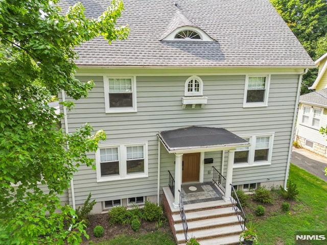 view of front facade with a shingled roof