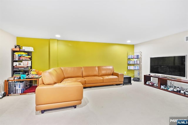 living area featuring visible vents, recessed lighting, and carpet flooring