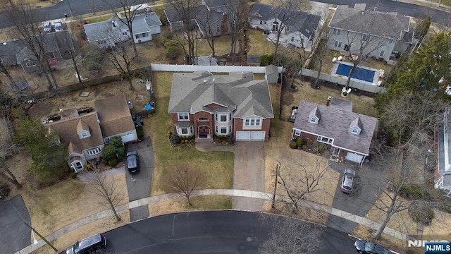 birds eye view of property with a residential view