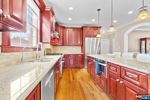 kitchen featuring crown molding, pendant lighting, reddish brown cabinets, and stainless steel appliances