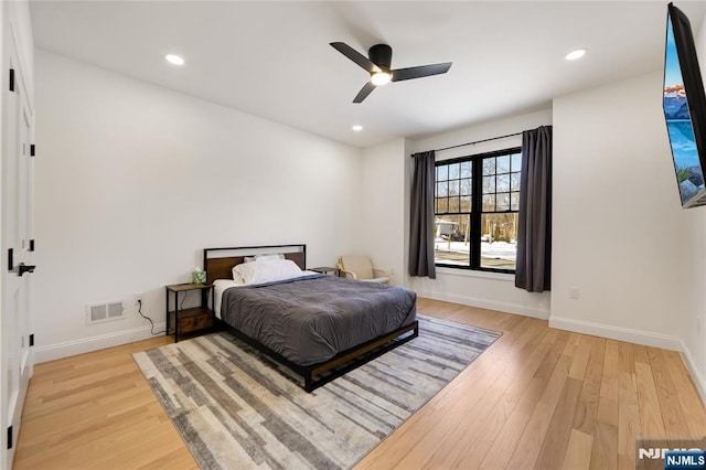 bedroom featuring baseboards, visible vents, and wood finished floors