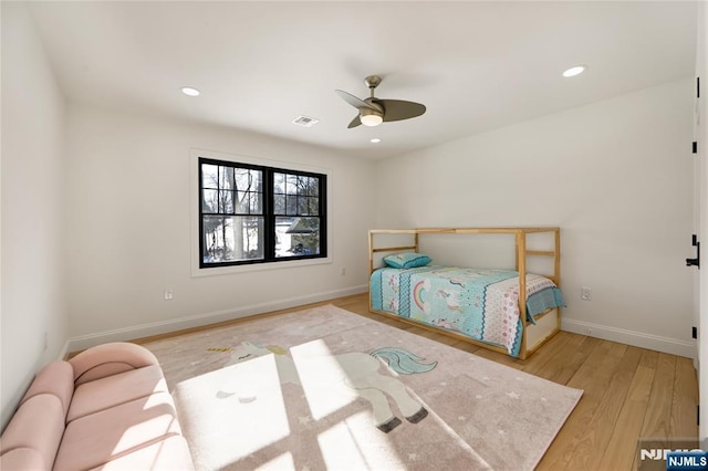 bedroom with recessed lighting, visible vents, baseboards, and wood finished floors