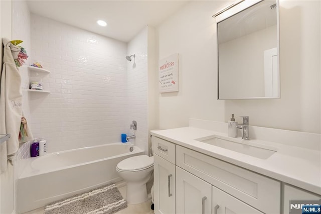 bathroom featuring toilet, tub / shower combination, and vanity