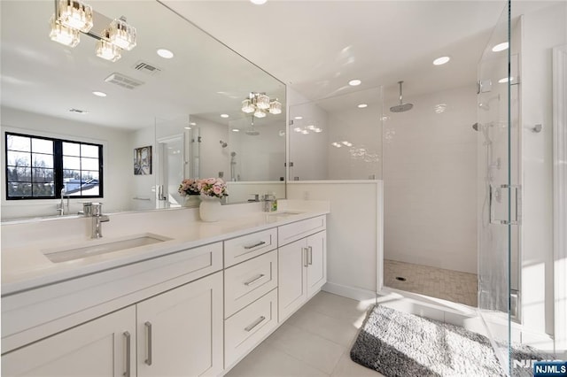 full bath featuring a shower stall, visible vents, and a sink