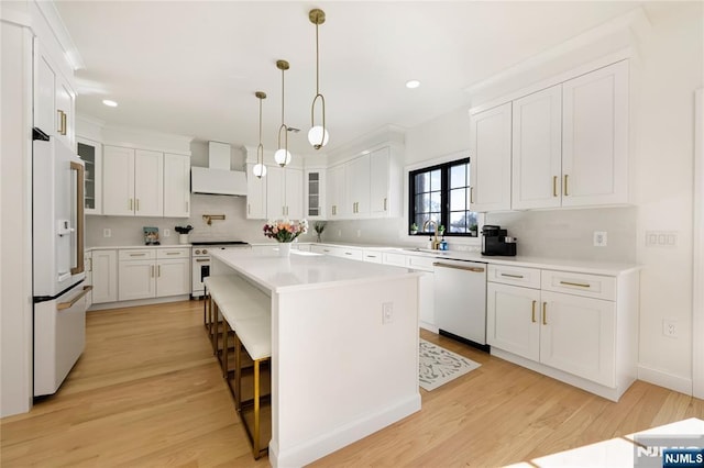 kitchen featuring premium range hood, high quality appliances, white cabinetry, light countertops, and glass insert cabinets