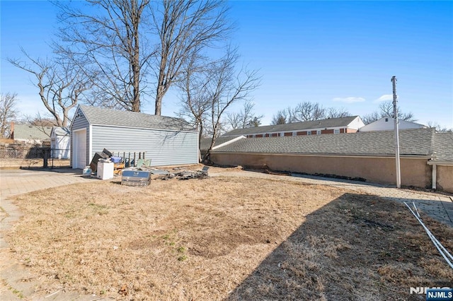 view of yard with an outbuilding and fence