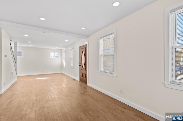 foyer entrance featuring light wood finished floors, plenty of natural light, baseboards, and recessed lighting