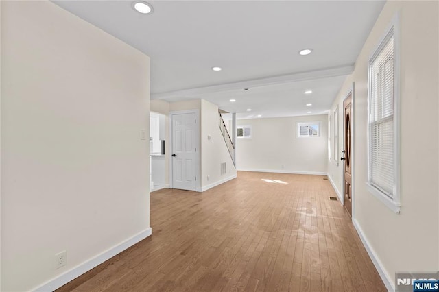 unfurnished room featuring recessed lighting, visible vents, light wood-style flooring, and baseboards