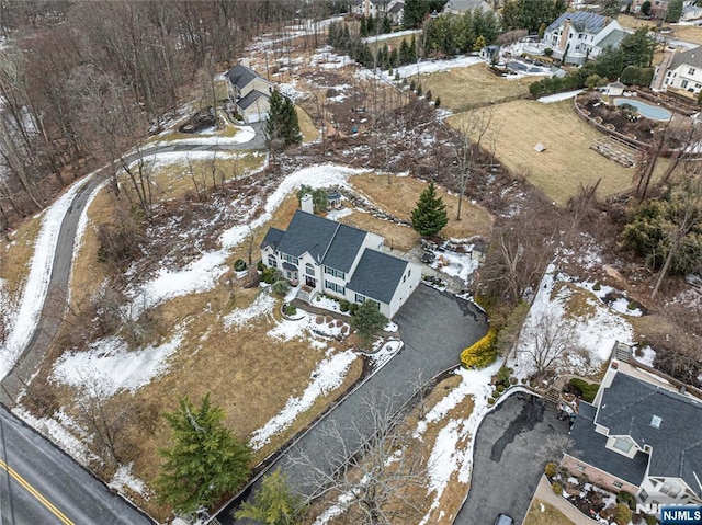 snowy aerial view with a residential view