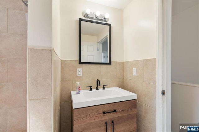 bathroom with tile walls and vanity