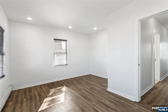 unfurnished room with dark wood-style floors, baseboard heating, baseboards, and recessed lighting