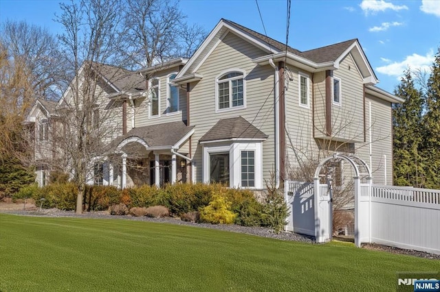 exterior space featuring a front yard and fence