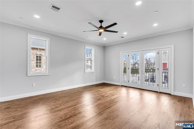 empty room featuring baseboards, visible vents, wood finished floors, french doors, and recessed lighting