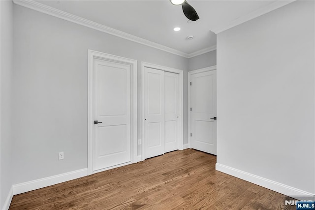 unfurnished bedroom with ornamental molding, recessed lighting, baseboards, and wood finished floors