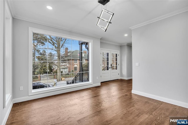 unfurnished room featuring ornamental molding, french doors, baseboards, and wood finished floors