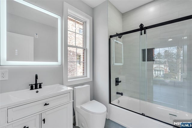 full bathroom featuring toilet, enclosed tub / shower combo, and vanity