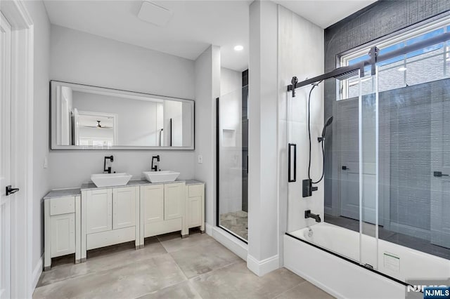 full bathroom featuring a shower with shower door, a sink, a bathing tub, and double vanity