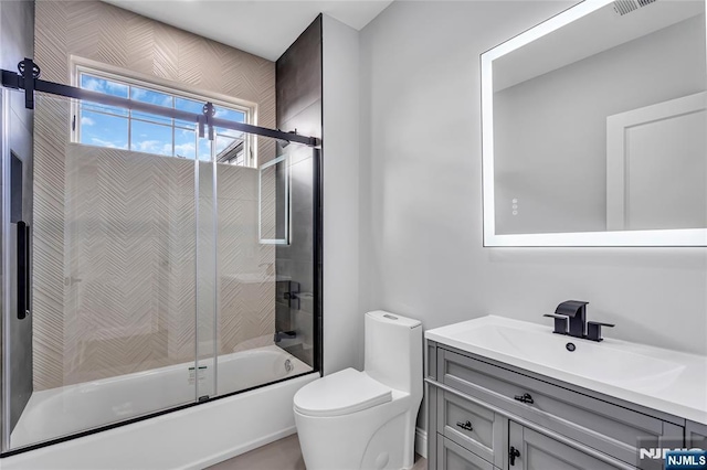 bathroom with toilet, enclosed tub / shower combo, and vanity