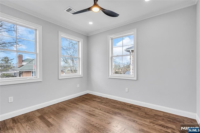 unfurnished room with dark wood-type flooring, a ceiling fan, and baseboards