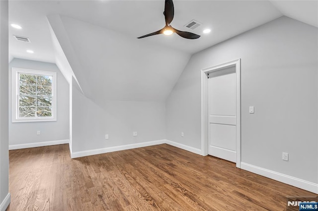 additional living space featuring baseboards, visible vents, and wood finished floors