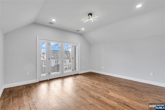 bonus room featuring lofted ceiling, baseboards, and wood finished floors