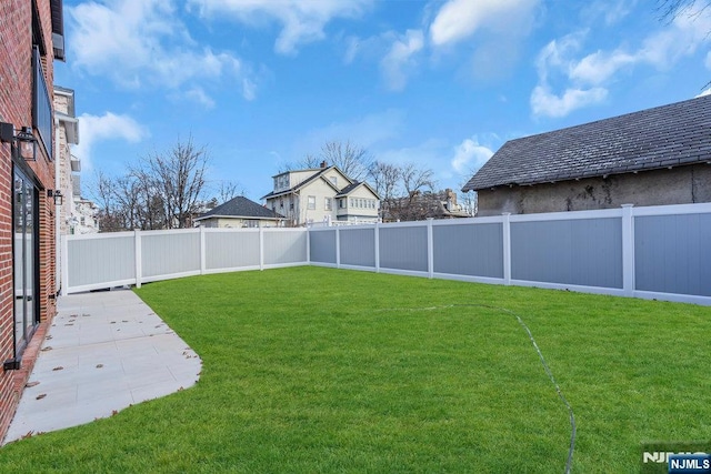 view of yard with a patio and a fenced backyard