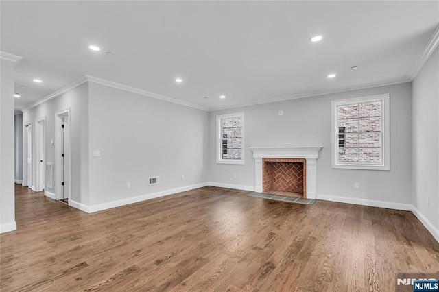 unfurnished living room with a tile fireplace, recessed lighting, wood finished floors, visible vents, and baseboards