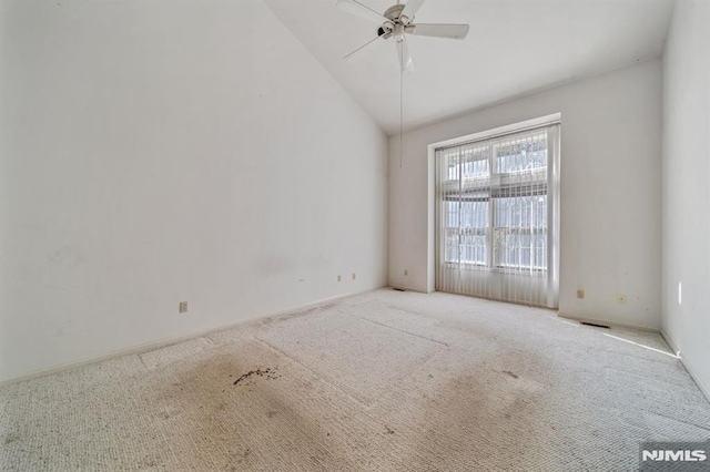 carpeted empty room featuring high vaulted ceiling and ceiling fan