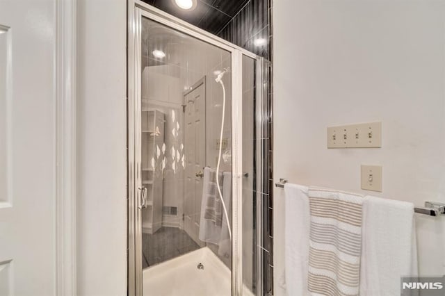 full bath featuring a shower stall