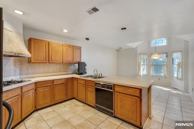 kitchen featuring black dishwasher, decorative backsplash, a peninsula, gas stovetop, and a sink